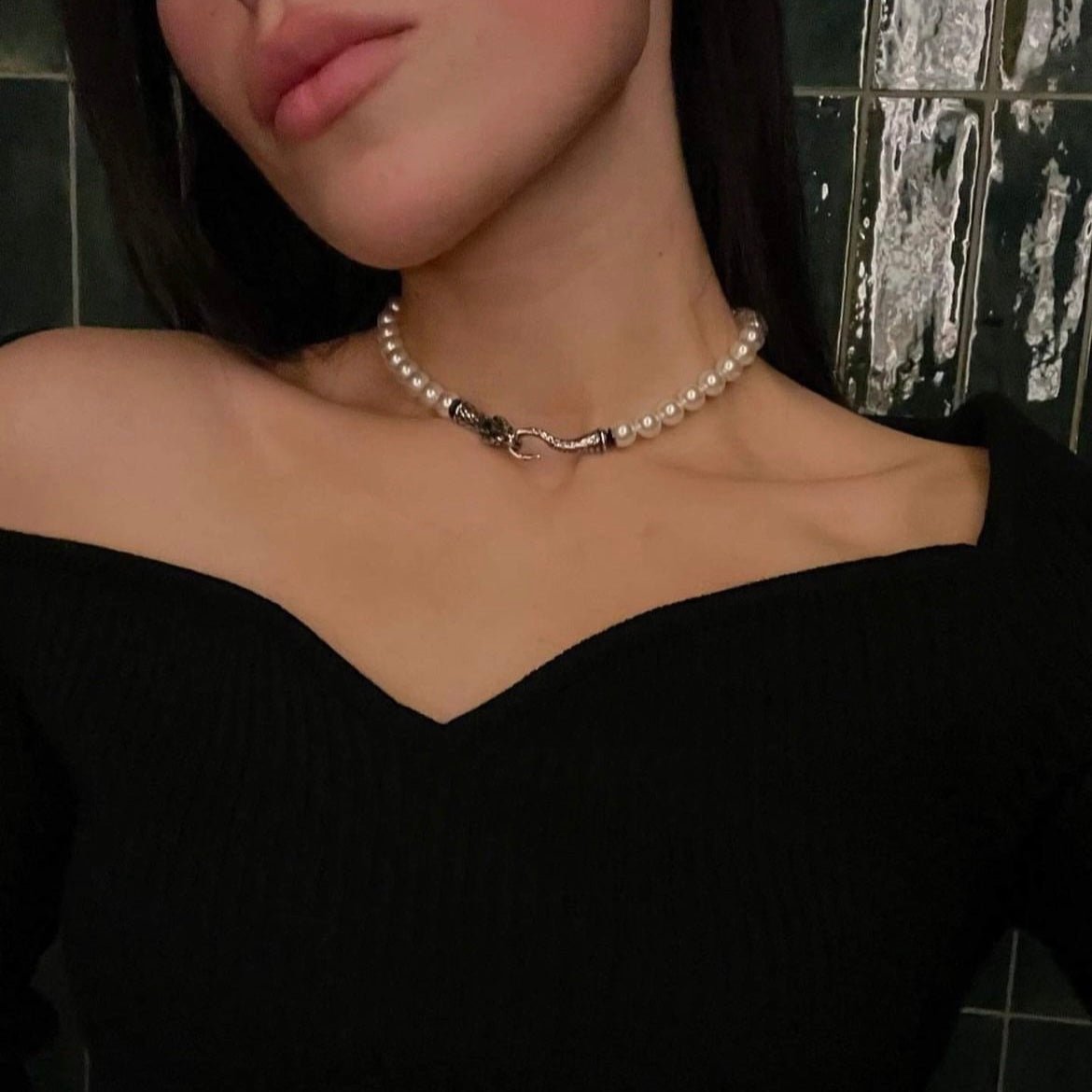 Ophidian Snake Choker on a female model with long dark hair against deep green background