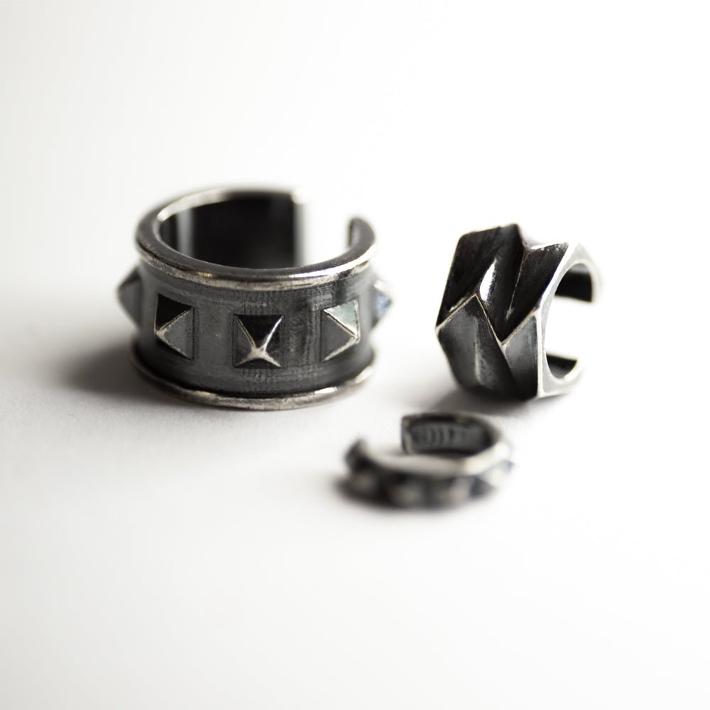 Wide studs ear cuff along with other ear cuffs by Macabre Gadgets in sterling silver on white background