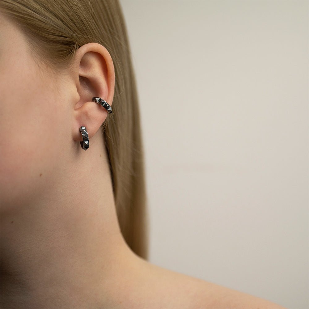 Female model with blonde hair wearing Studs Hoop earring and ear cuff, minimalist geometric jewelry styling