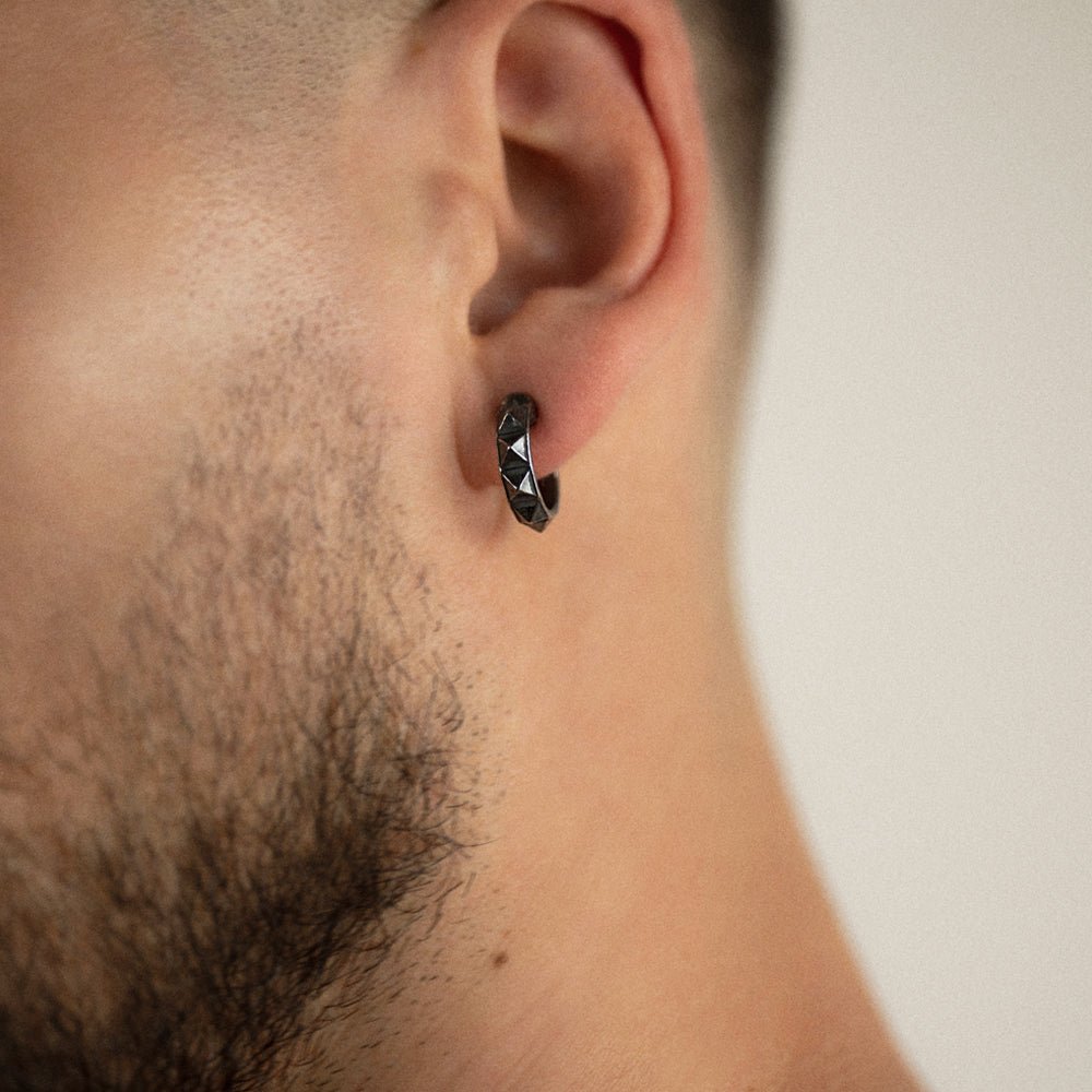 Male model wearing Studs Hoop earring close-up, handcrafted geometric pyramid jewelry lifestyle shot