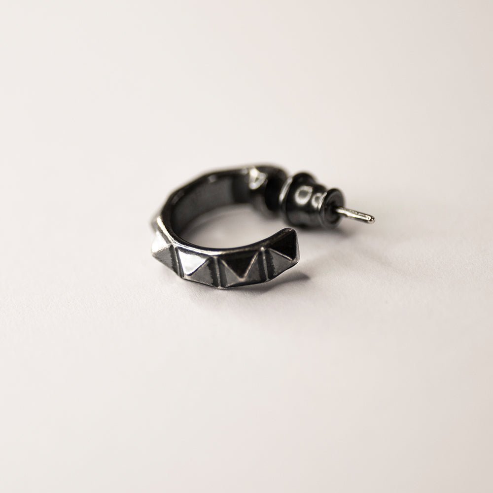 Studs Hoop earring - sterling silver hoop with studs on white surface, demonstrates a stud lock mechanism 