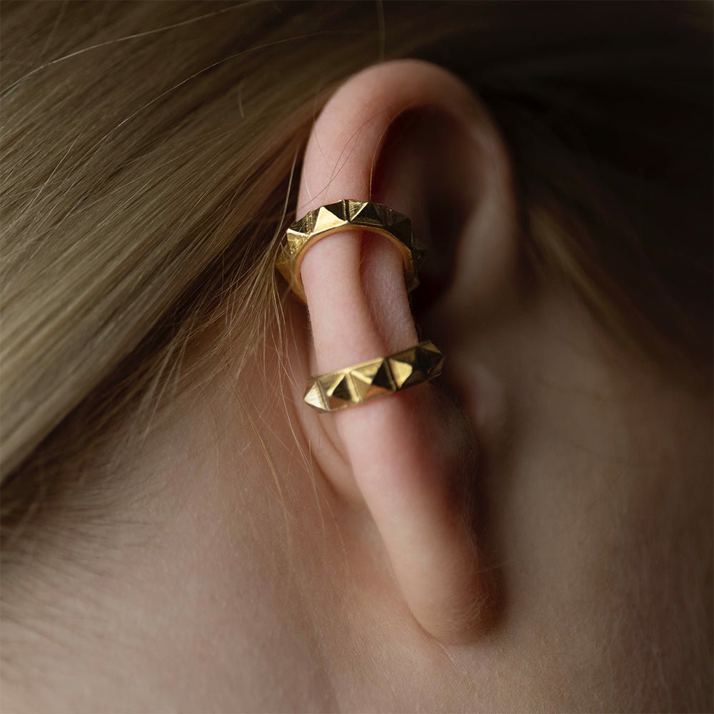Pyramids ear cuff on a model's ear -  designed to fit snugly around the ear without the need for piercing