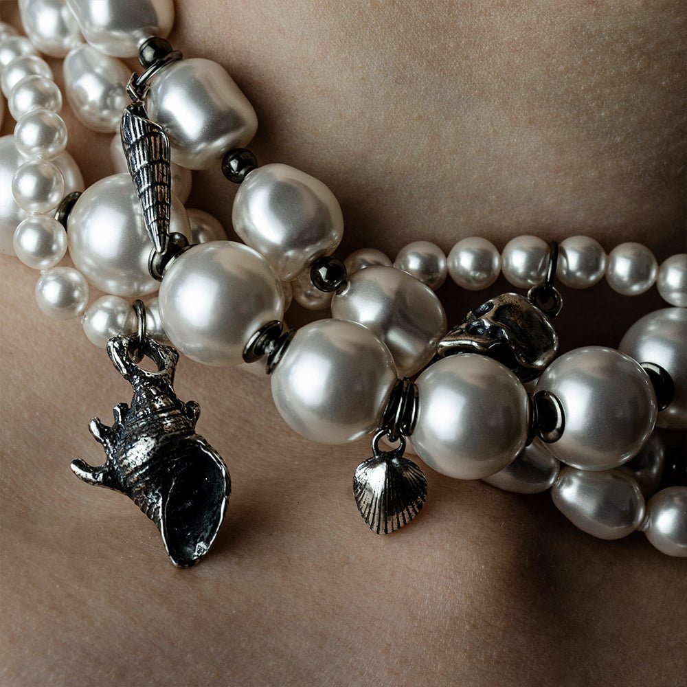 Siren Pearl Necklace - close up of various sterling silver shells between pearl strings