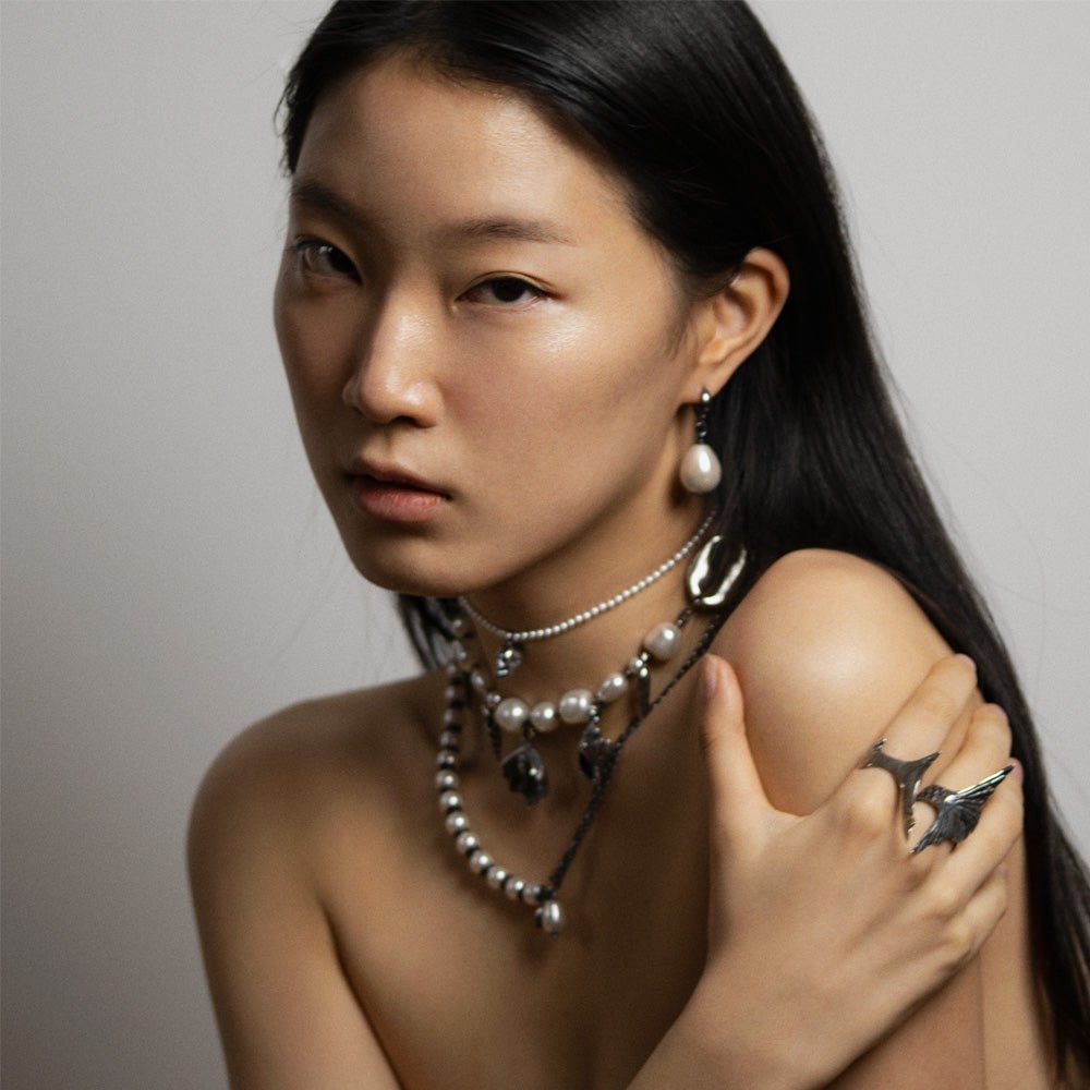 Female model wearing Siren ring with other chains, necklaces and earring by Macabre Gadgets - fashion editorial