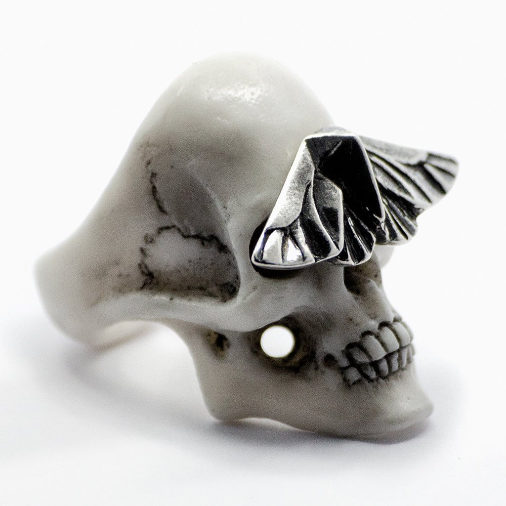 Skull & Moth ring - white variant - semi side view, different angle, focus on the skull's texture and moth's silver polished surface