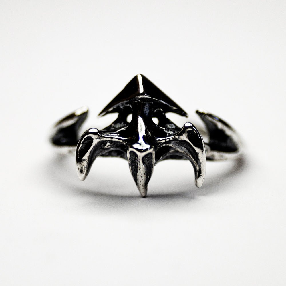 Vertebra ring  - front view of the ring on white surface, focus on sculpted details