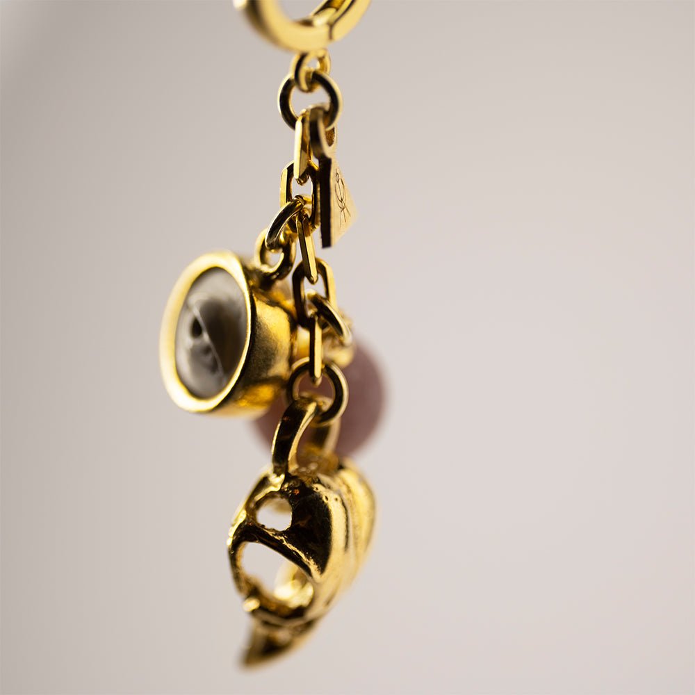 Close-up of Woods Charm earring - gold-plated charm dangle earring on a hoop