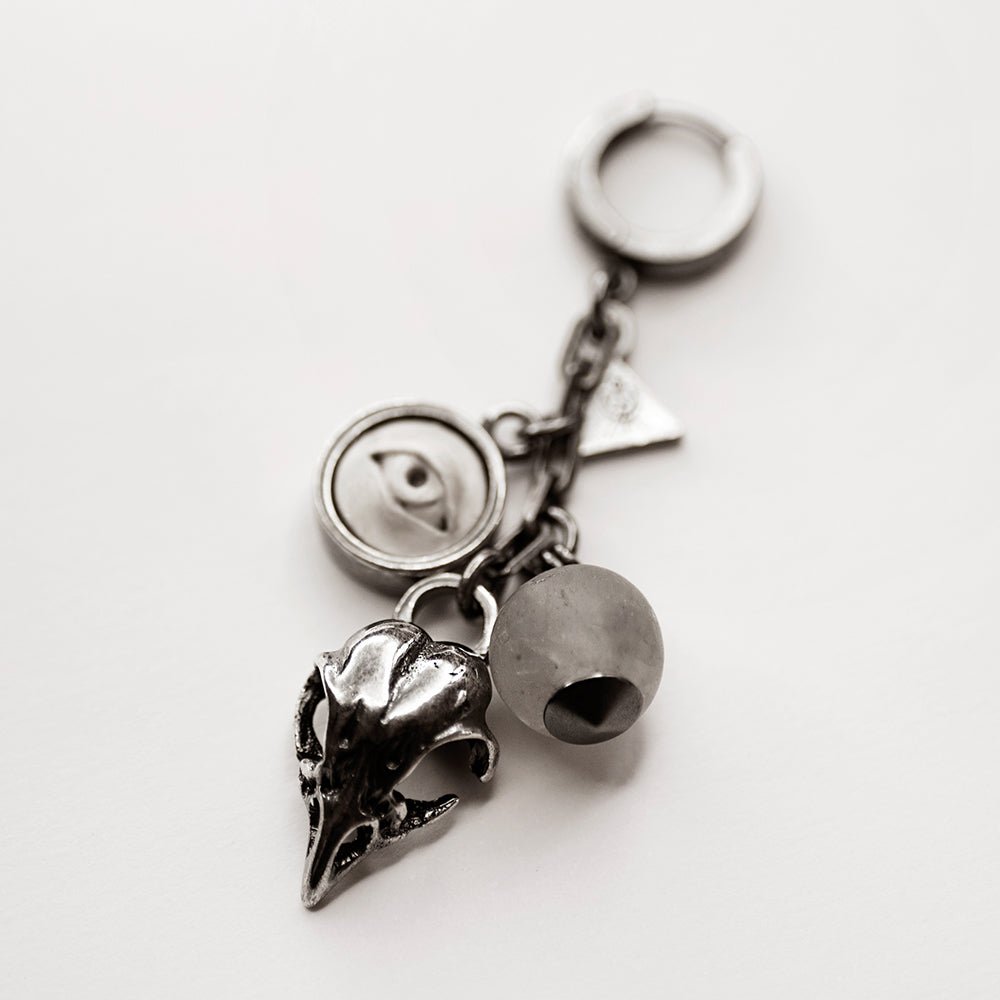 Woods Charm earring in sterling silver on a white surface 