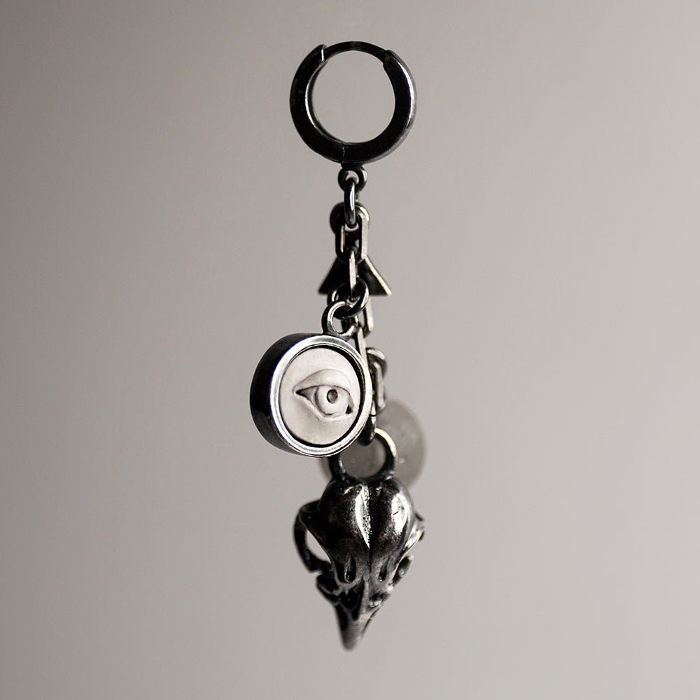 Woods Charm earring - number of charms including miniature bird skull, marble eye relief and natural stone beads on neutral background